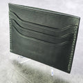 black  leather wallet on a textured gray surface