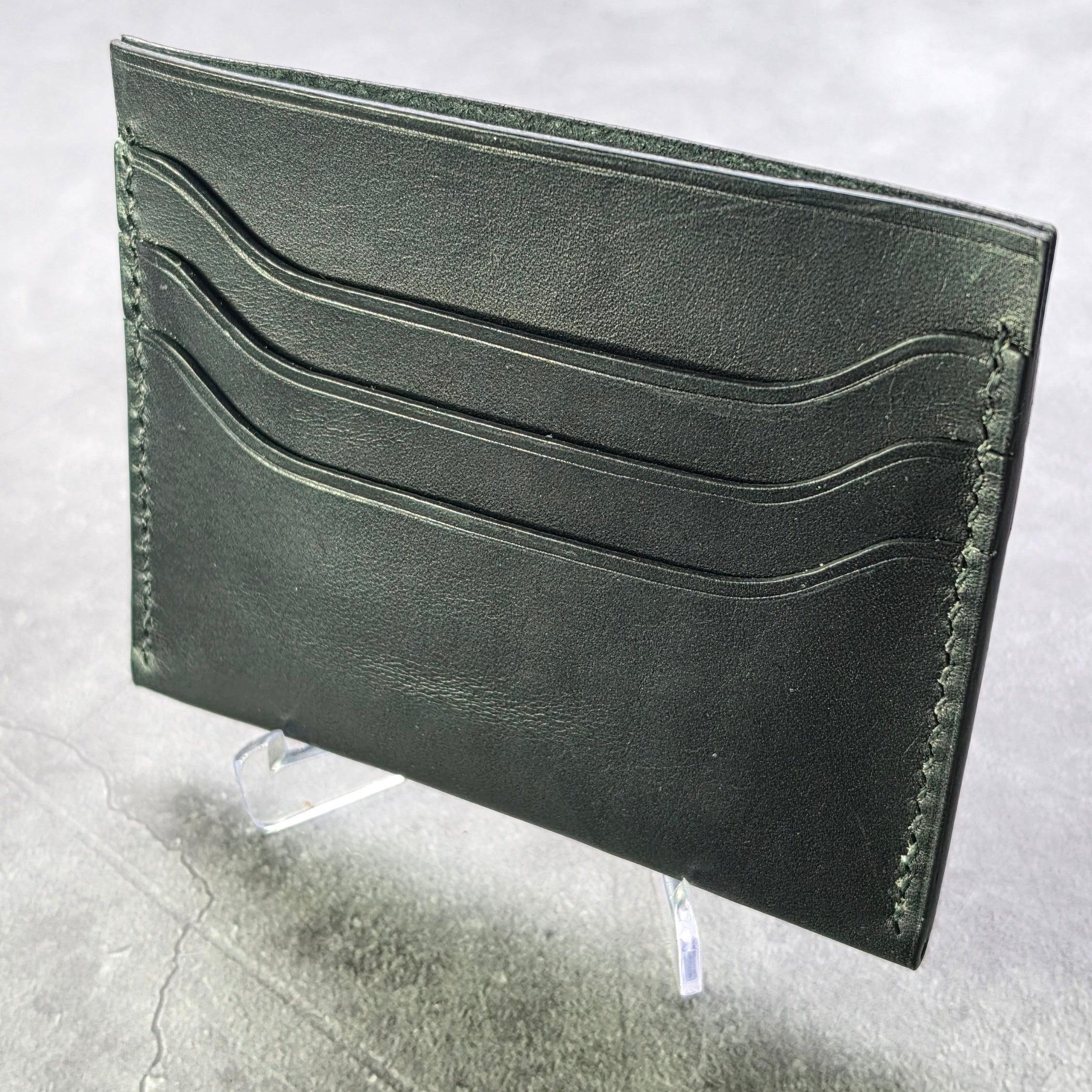 black  leather wallet on a textured gray surface