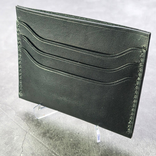 black  leather wallet on a textured gray surface